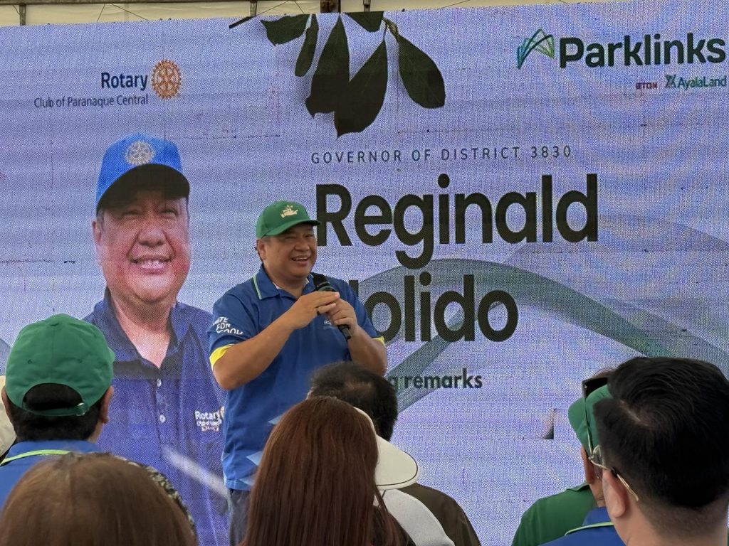 District Governor Reginald Nolido delivers his message beside the Parklinks backdrop.
