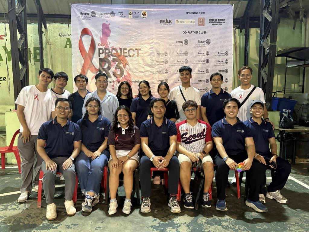 Organizers and partner organizations pose together under the Project R3 backdrop.