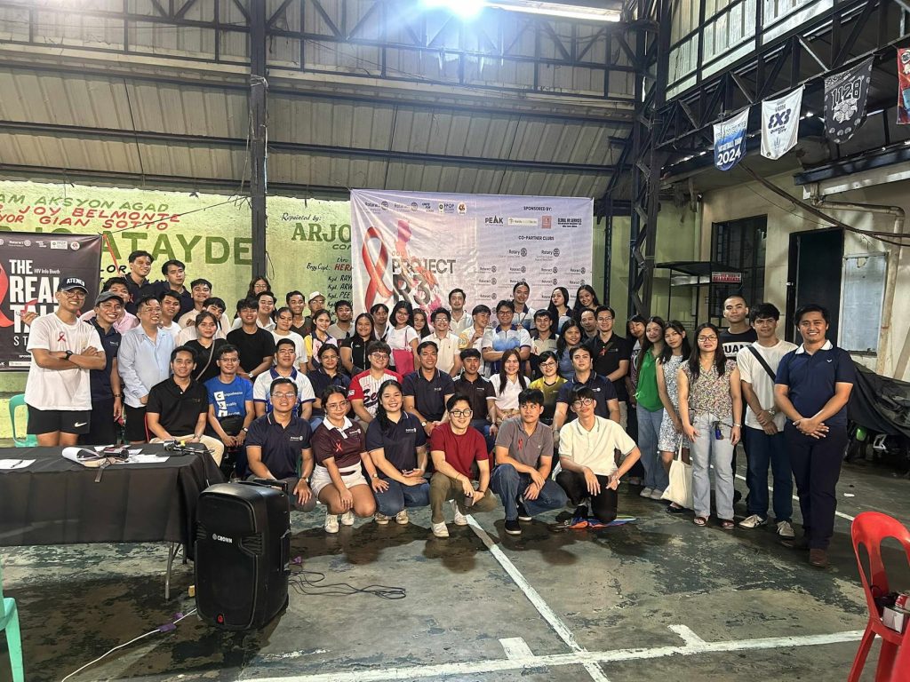 Participants and volunteers gather at the covered court during the HIV Awareness Fair.
